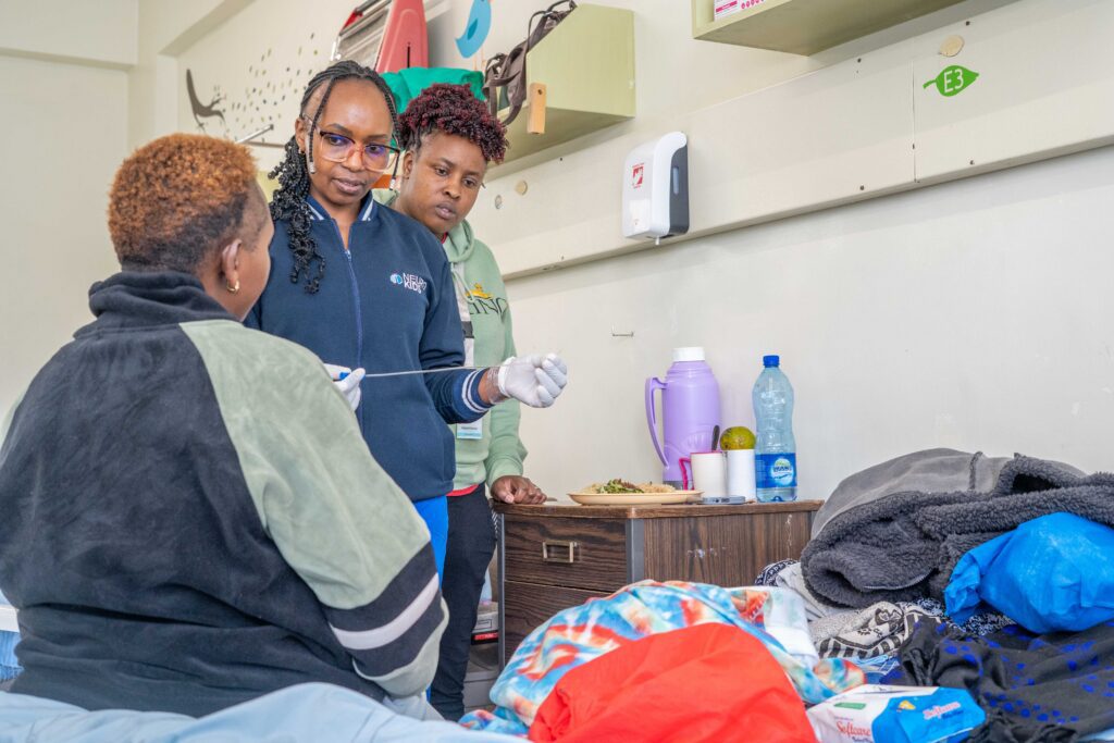 Anne teaching a guardian how to perform clean intermittent catheterization (CIC)